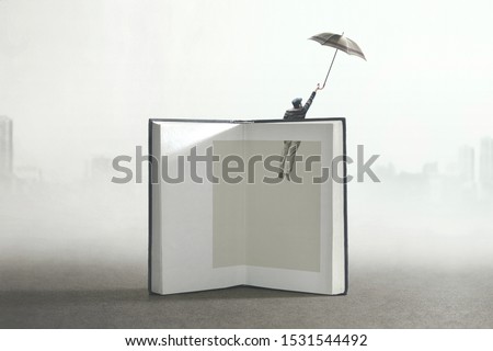 man flying out of a book; surreal concept Royalty-Free Stock Photo #1531544492