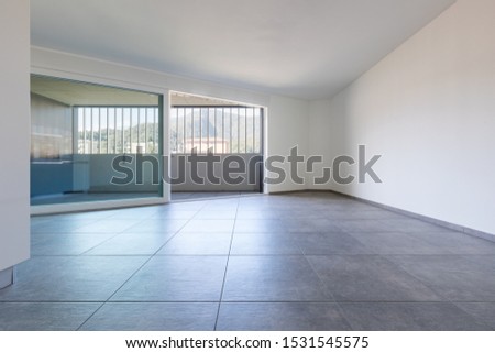 Front wall view with large window with covered balcony and view of the Swiss mountains. Nobody inside