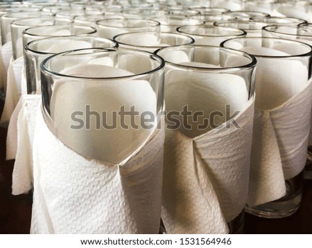 Empty glass bottles wrapped in tissue paper in a row. Taken from the top view. Empty water glass abstract.