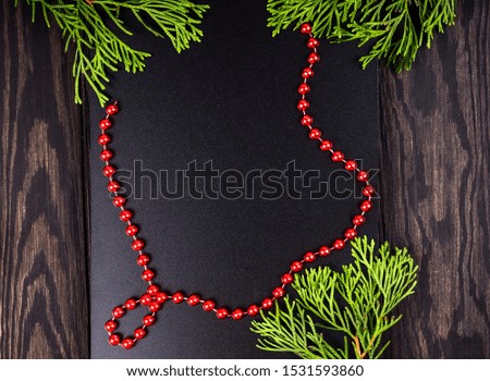 Christmas Border. Fir tree branches on dark wooden background. Top view. Copy space.