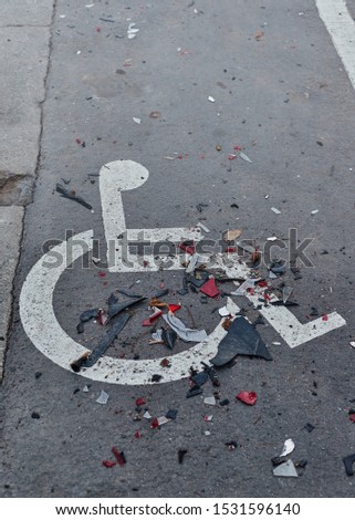 road safety concept. Details from a wrecked car after a terrible accident on the background of an invalid parking space.