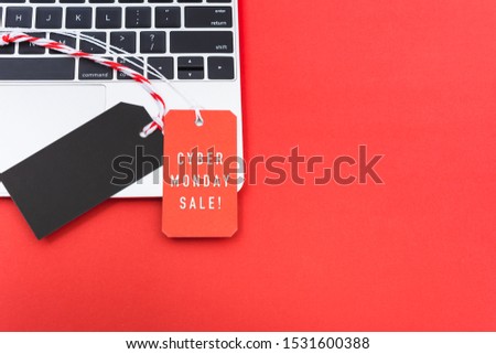 Online shopping Cyber Monday text with red tag label and Blank black red tag on laptop computer, with copy space red background