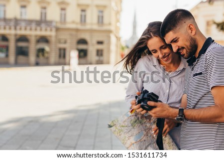 couple tourist in sightseeing in city using photo camera