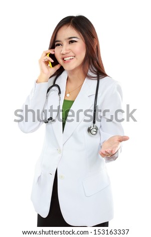 Attractive female doctor in lab coat with stethoscope talking with cellphone isolated over white background