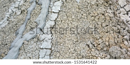 Earth cracks of Mud Volcanoes in Gobustan near Baku Azerbaijan. A mud volcano or mud dome is a landform created by the eruption of mud or slurries, water and gases