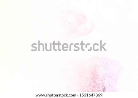 Colorful powder/particles fly after being exploded against white background