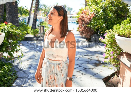 Young beautiful woman smiling happy enjoying sunny day of summer at hotel resort on holidays