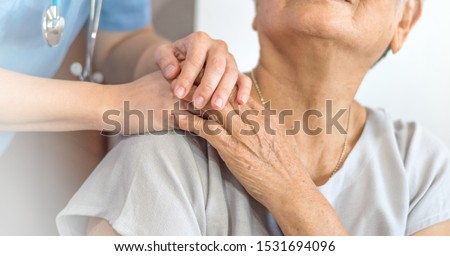Geriatric doctor or geriatrician concept. Doctor physician hand on happy elderly senior patient to comfort in hospital examination room or hospice nursing home or wellbeing county.  Royalty-Free Stock Photo #1531694096