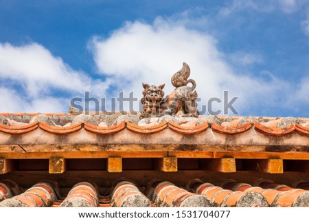 An ancient lion statue(Shisa) placed on the roof of a house on Okinawa Island According to belief that dispel evil