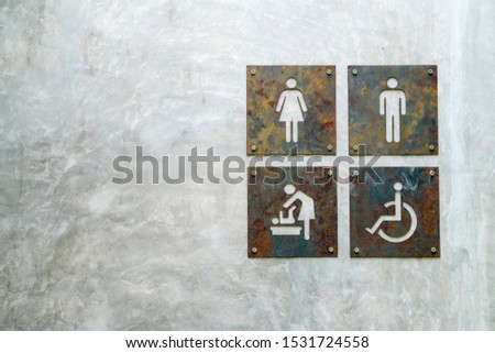 Rest room signage rusted metal symbol on concrete wall unisex handicap baby's room