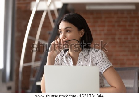 Thoughtful Asian businesswoman taking off glasses, pondering ideas, developing business strategy, looking in distance, using laptop, pensive employee taking break, dreaming or visualizing in office Royalty-Free Stock Photo #1531731344