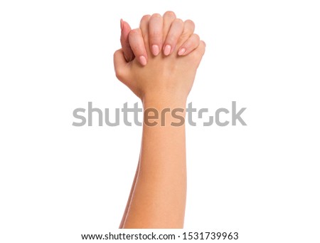 Female hand with fingers folded into fists, isolated on white background. Beautiful hand of woman with copy space, winning gesture.
