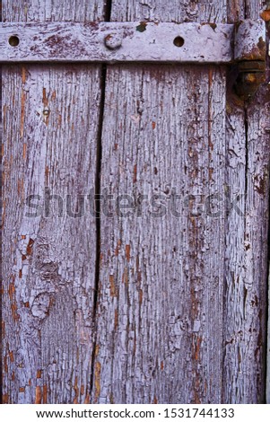 Vintage wood background with peeling paint, purple color