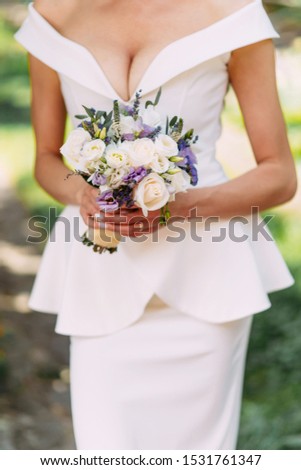 Wedding bouquet in bride's hands. Close-up. Wedding Accessories Bride