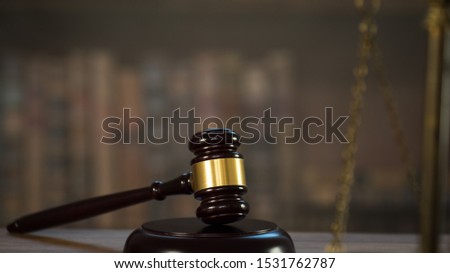 Law and Justice concept. Mallet of the judge, books, scales of justice. Courtroom theme.