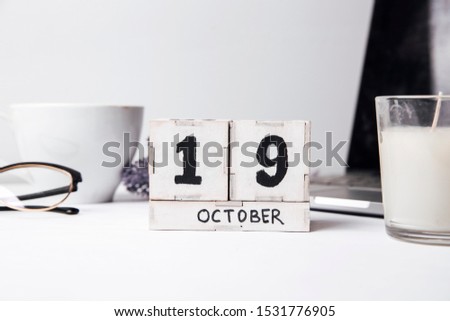 October 19th . October 19 white wooden calendar on white background. Autumn day. Copy space for your text.