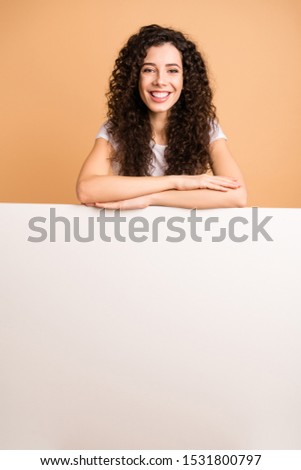 Photo of amazing lady leaning hands on empty discount banner white placard offer buyer cheap advert wear white casual clothes isolated beige pastel color background