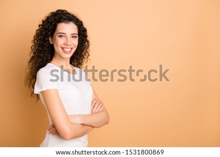 Photo of pretty business lady with crossed arms toothy beaming smiling self-confident person wear white casual clothes isolated beige pastel color background