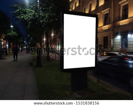 vertical small city billboard advertising city format. mockup at night with white field billboard