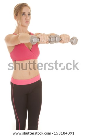 A woman in a pink bra holding out weights.