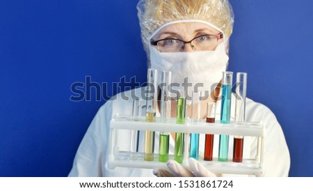 Medical doctor in mask with many tests tubes on blue background