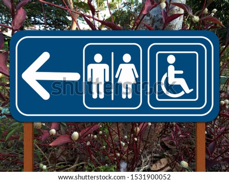 Public restroom signs with arrow