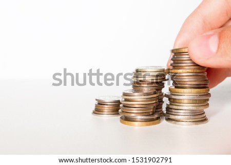 man makes a stack of coins on white background with space for text. business growth concept
