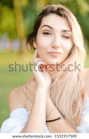 Portrait of young nice female person, green background. Concept of beauty and everyday makeup.