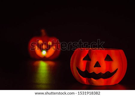Smiling of scary pumpkin on dark background in Halloween.