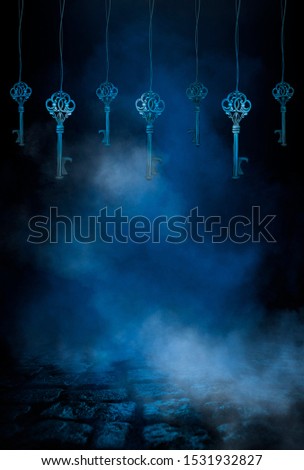 Dark night magic scene with a garland of old keys. Night view, smoke, magic, magical experience, a fabulous night. Blue neon, moonlight at night. Wet asphalt, reflection.