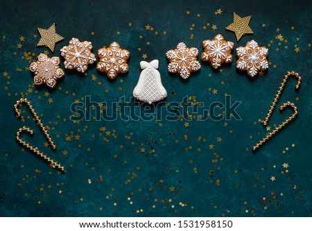 Christmas greeting frame - pattern of gingerbread cookies, snowflakes and Christmas decor on a green background