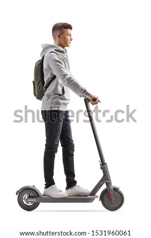 Full length profile shot of a male student with a backpack riding an electric scooter isolated on white background Royalty-Free Stock Photo #1531960061