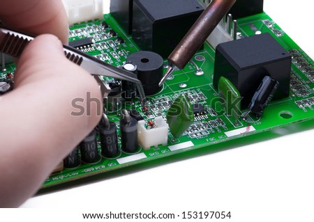 Electronic technician operates with circuit board. Close-up. 