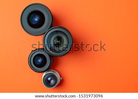 Progress of different photo lenses on a colored background, a set of modern photo devices for the camera, copy space