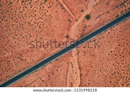 Aerial shot of a straight highway in the middle of the Arizona desert