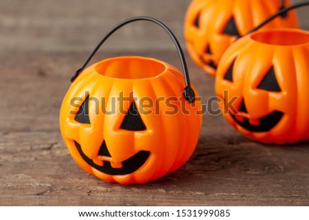 Halloween. Pumpkin basket for sweets on a wooden background