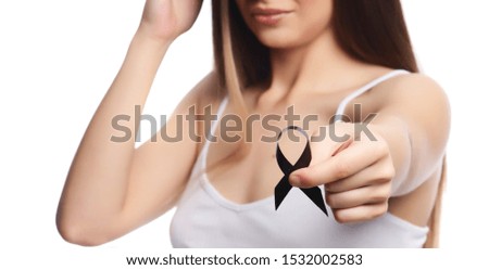 beautiful brunette model holding black ribbon isolated
