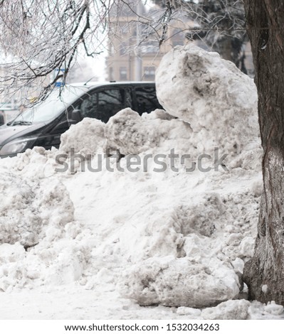 Big abnormal snowfall in the city. Street cleaning and snowdrifts. Snow and collapse of communal services. Stock photo for demonstration