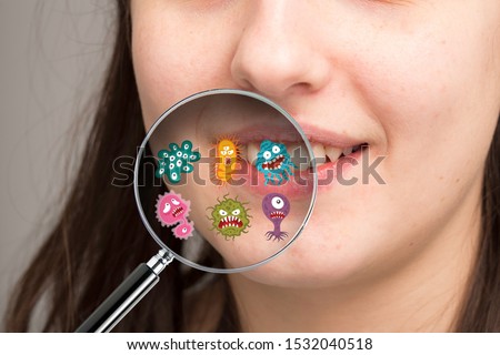 Magnifying glass showing possible microbes of the oral cavity re Royalty-Free Stock Photo #1532040518