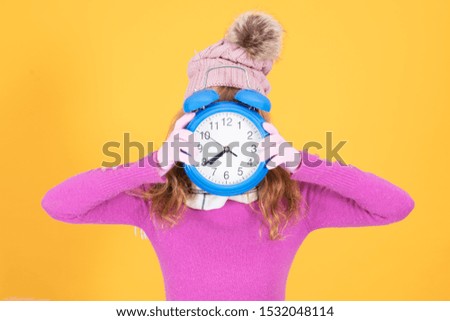adult woman with alarm clock or alarm on color background