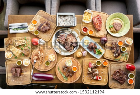 Barbecue restaurant menu. Many different food on the table. Dinner party or Banquet. Top view
