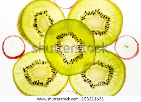 Kiwi fruit slice on a light background.