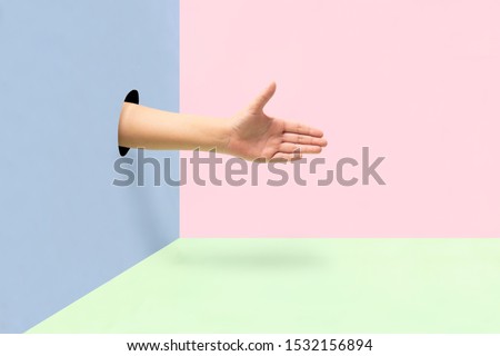 Female hand offering a greeting on colorful background.