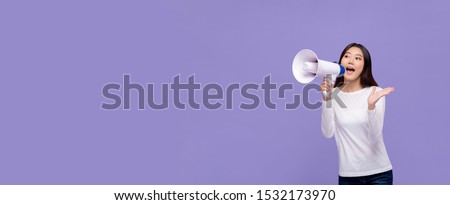 Beautiful Asian woman announcing on magaphone isolated on purple banner background with copy space Royalty-Free Stock Photo #1532173970