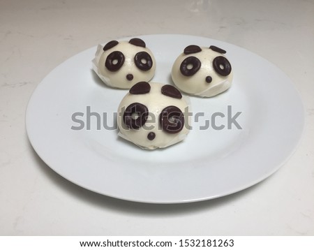 Endangered species panda bear dumpling steamed buns on a plate for dinner, a snack or dessert.