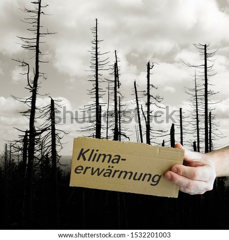 Cardboard sign with the inscription Global Warming. In the background a dead forest. Royalty-Free Stock Photo #1532201003