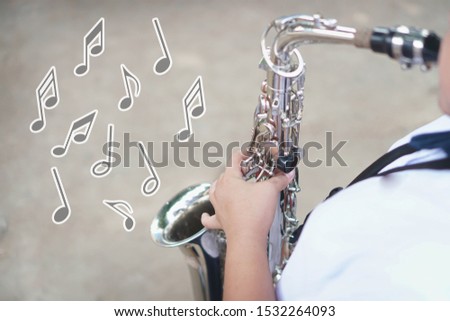 Music notes and symbols,Young student Musician playing the Saxophone with Music practice of Band, Musical concept