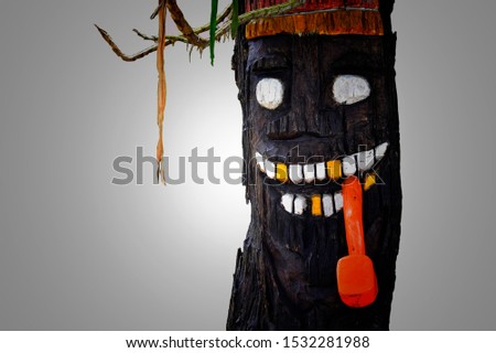 Isolated black spooky tree with red tobacco pipe.