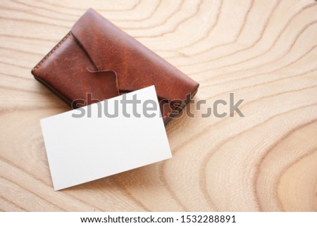 blank business card with leather card case on the wooden table