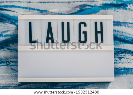 "LAUGH" word on a Lightbox